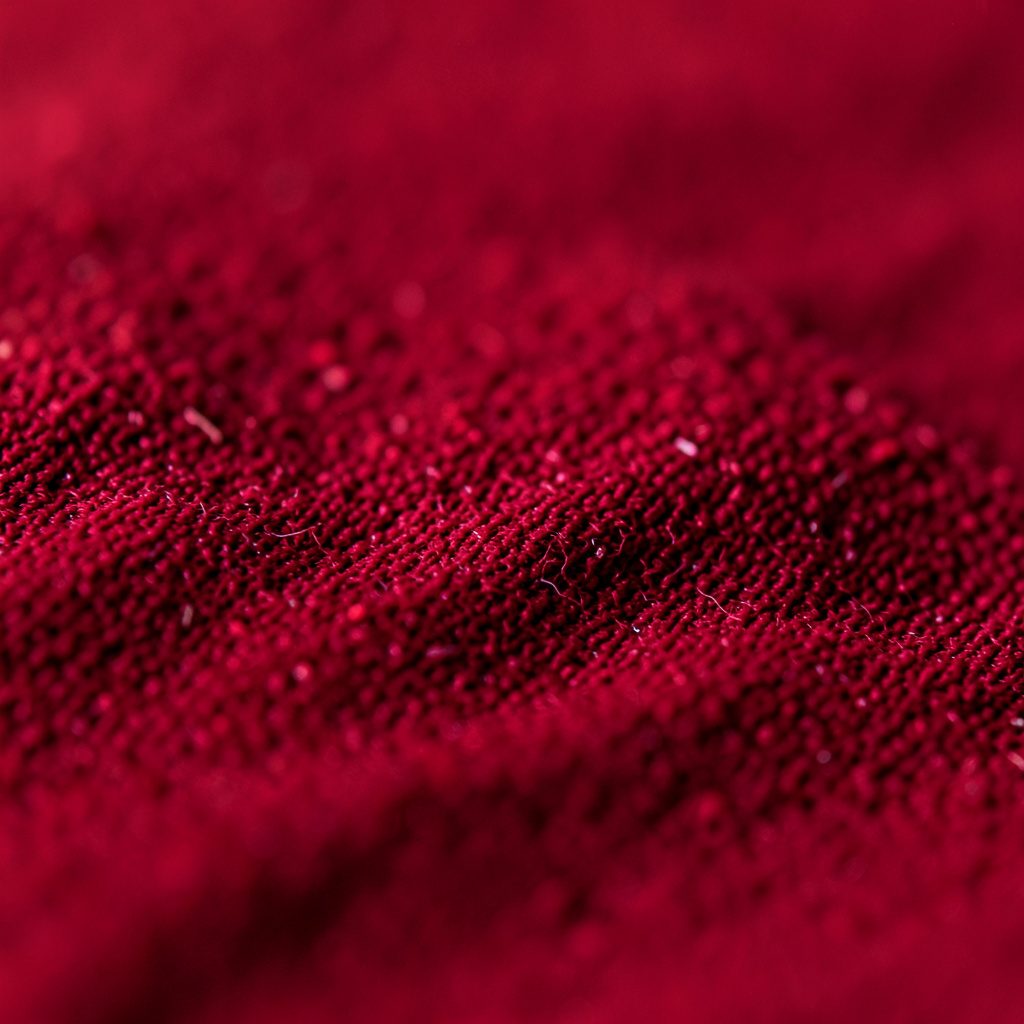 Close-up of a vinyl record surface with warm amber and deep red light reflecting off its grooves, moody and atmospheric